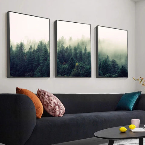Tall evergreen pines rise through layers of soft, enveloping mist in a lush forest.