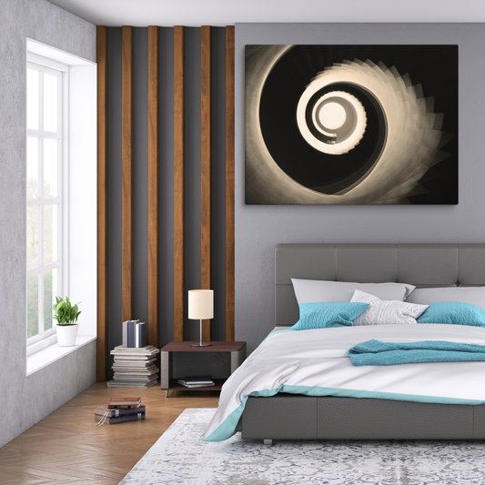 Sepia-toned view looking up a grand spiral staircase, with smooth curving steps and ornate railings forming perfect concentric circles that draw the eye.